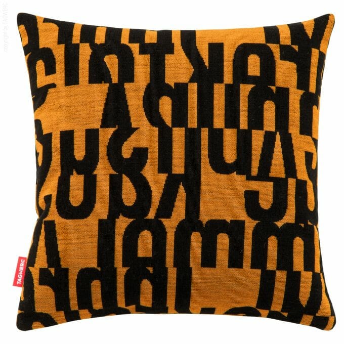 The cushion by TAGWERC with the letters pattern in black and tangerine by designer Gunnar Aagaard Andersen.